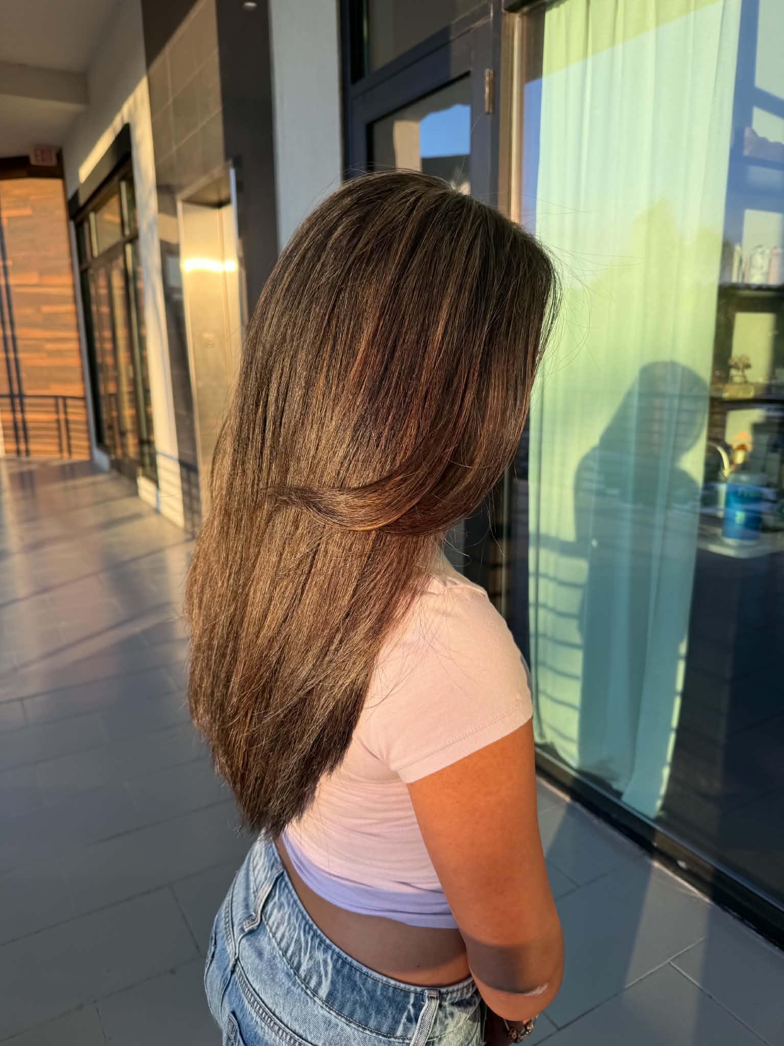 Smooth medium brunette hair with a precision layered shape