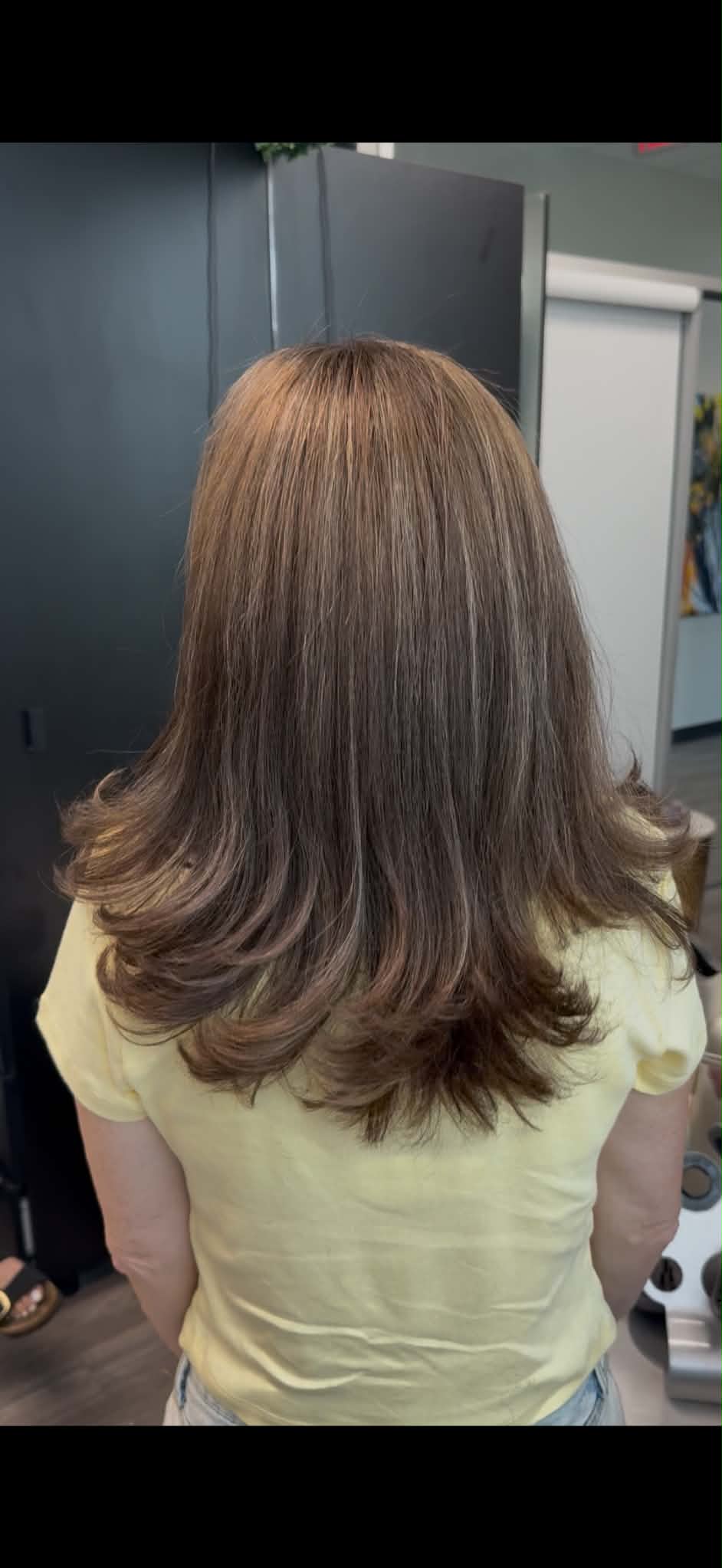 Medium brunette hair shaped with airy flowing layers