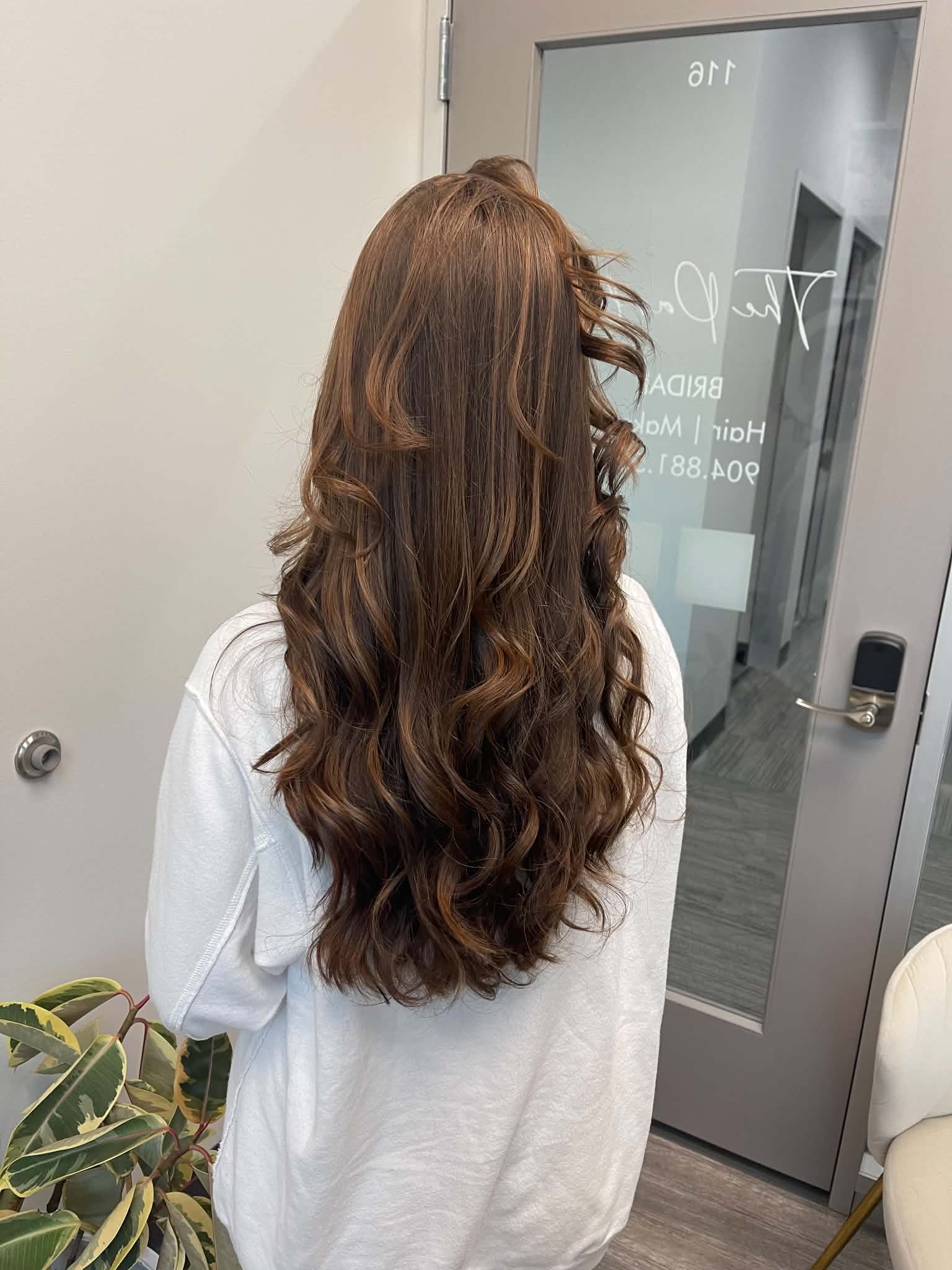 Long chocolate brunette hair styled in softly separated curls