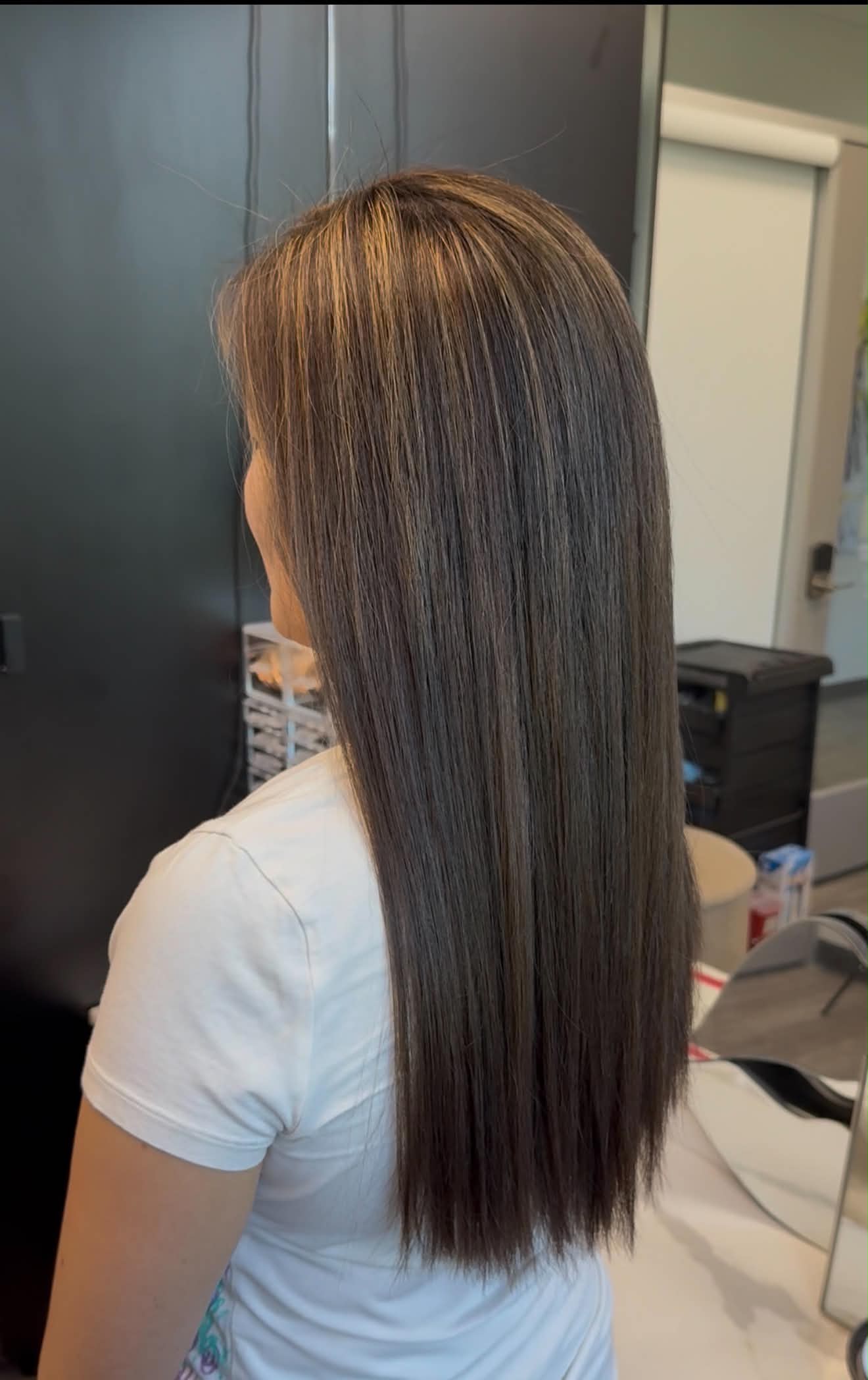 Long sleek brunette hair with a mirror-like finish