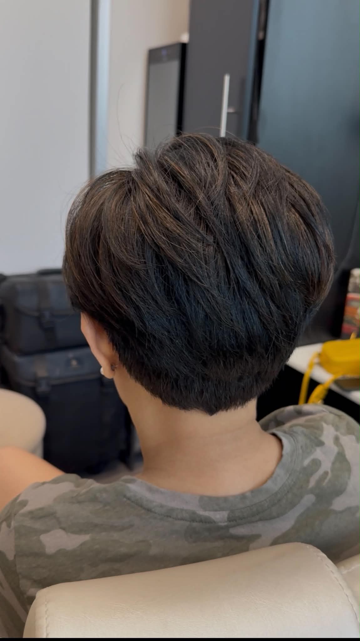 Precisely sculpted dark pixie haircut viewed from the back